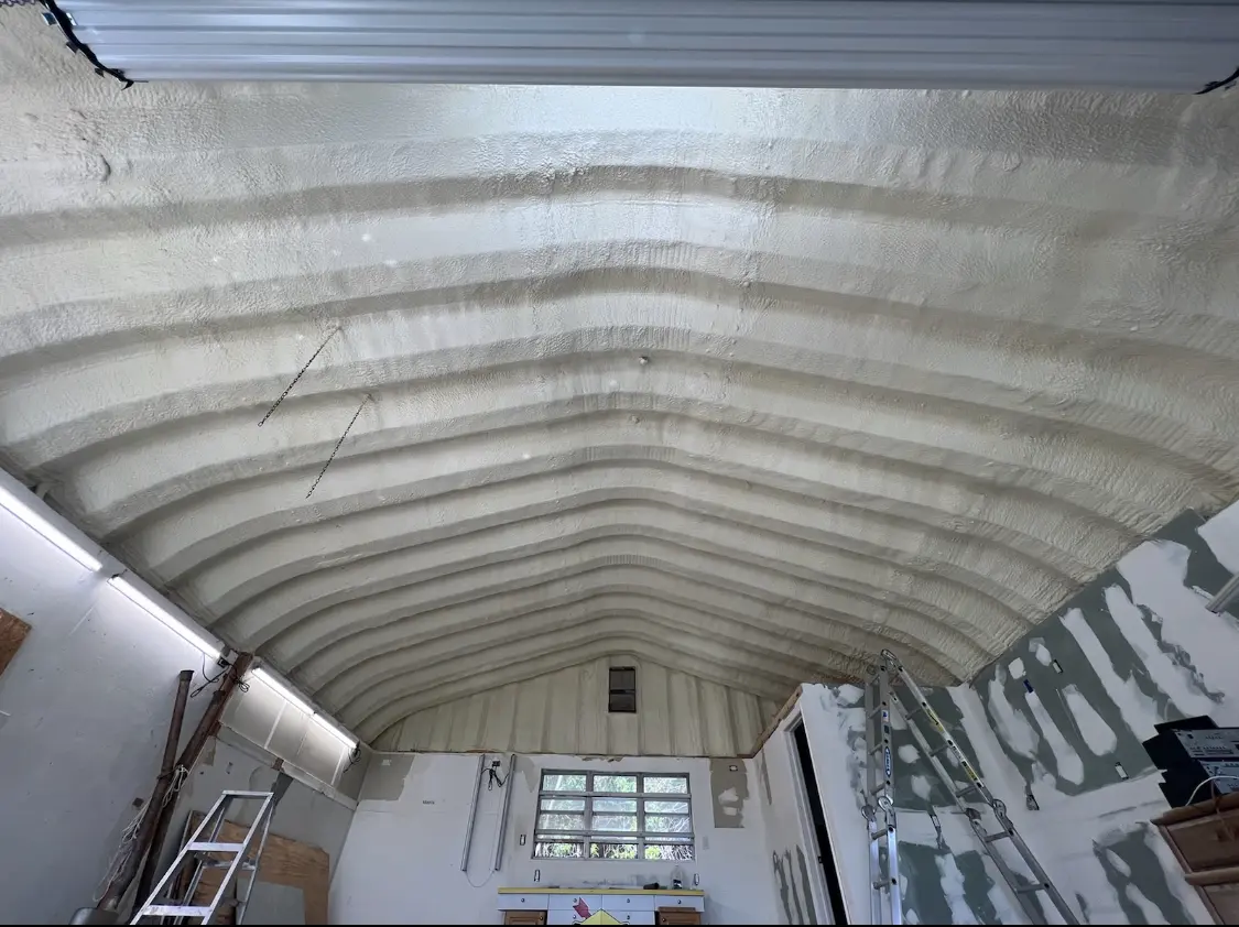 Spray polyurethane foam applied to the underside of a metal roof deck in Dundee
